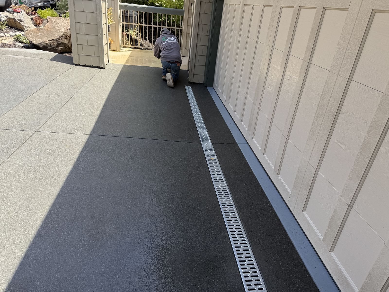 Channel drain installed along garage