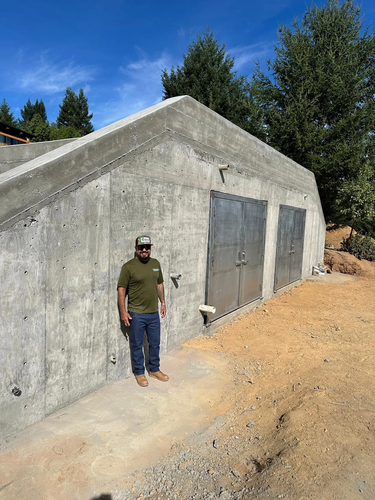 Carlos Ortiz, CEO of San Carlos Concrete, in front of a finished concrete bunker